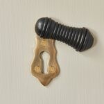 ebony and brass escutcheon