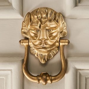 large lions head door knocker aged brass