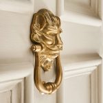 large lions head door knocker aged brass