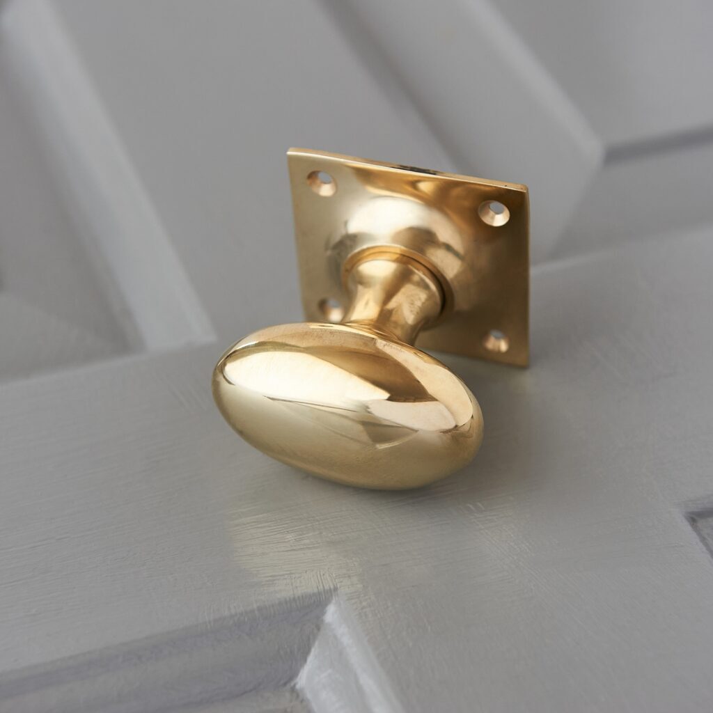 Oval Door Knobs on Square Back Plate (Pair) Polished Brass