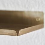 ledged brass shelf
